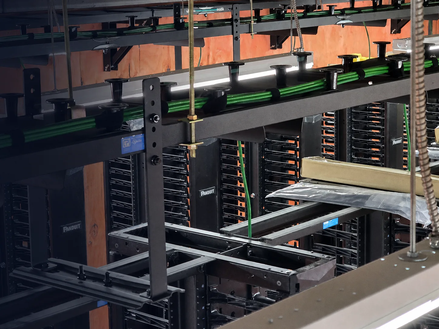 Real WiredOptics copper data cabling routed above commercial network racks.