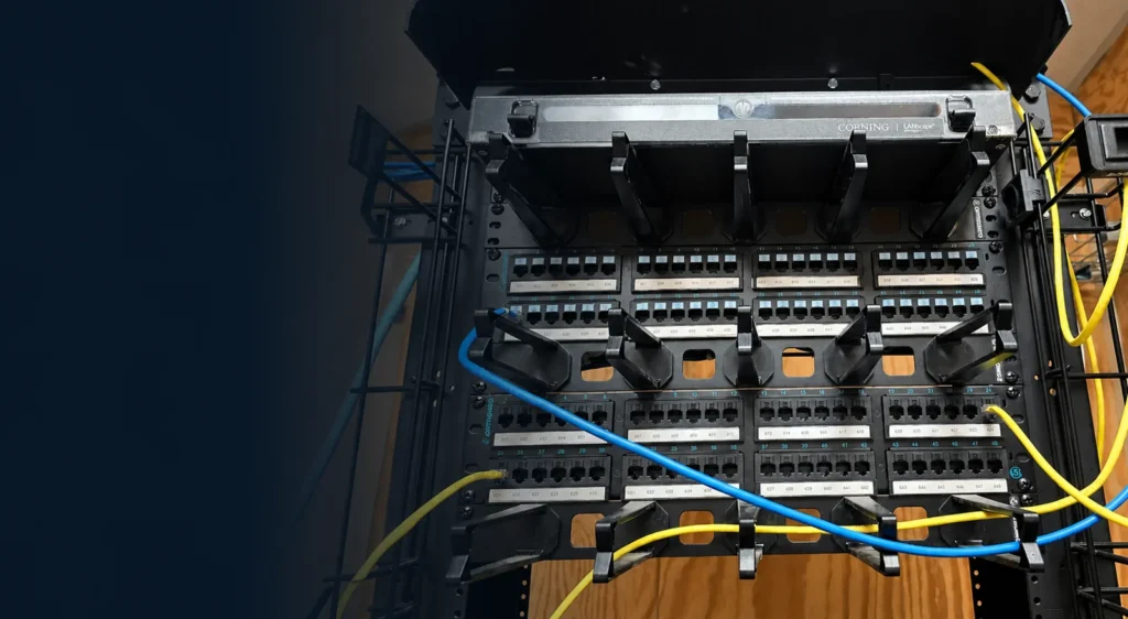 Commercial network rack showing copper patching and fiber components.