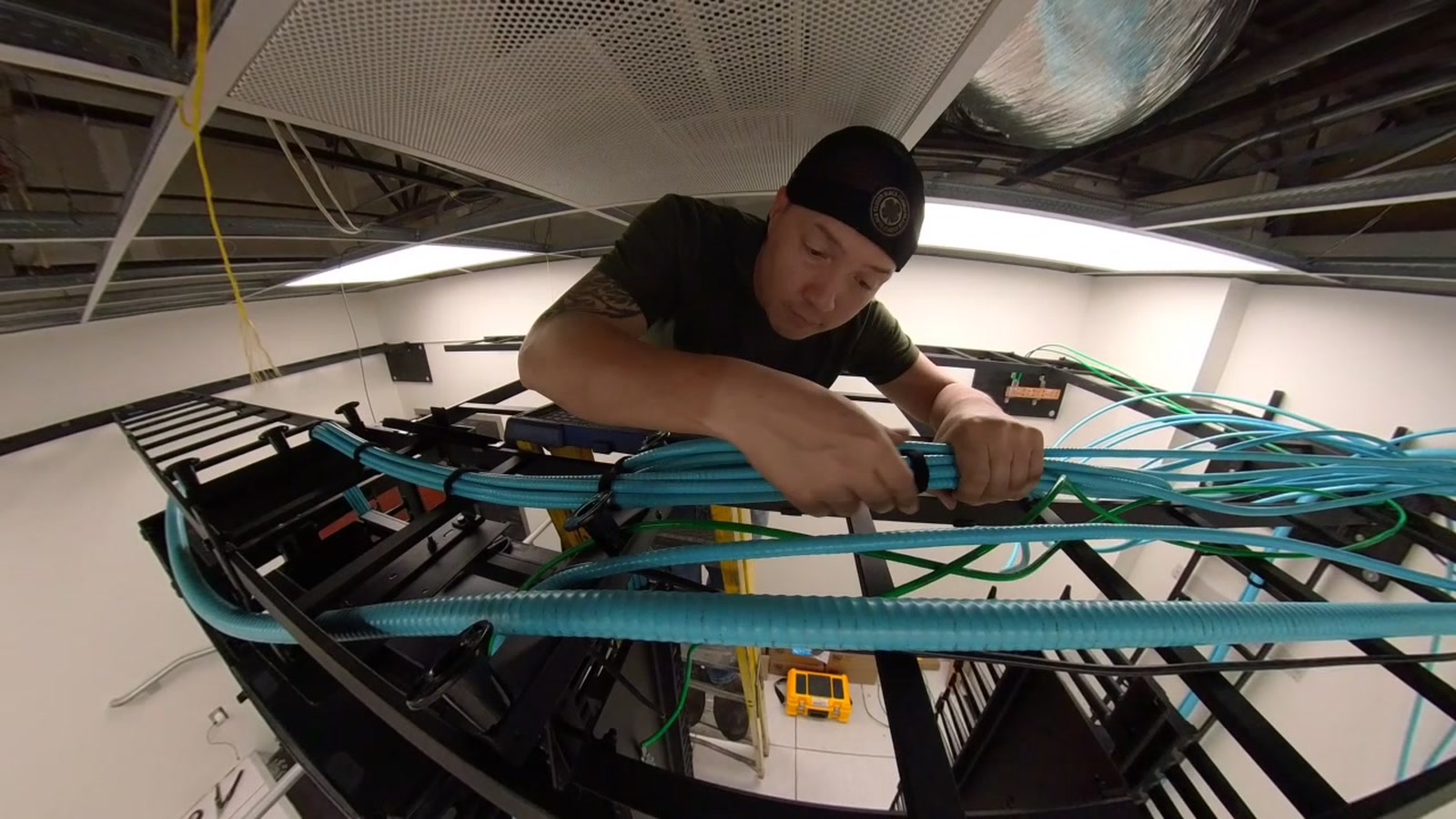 Brad Dahl dressing commercial network cabling at an onsite equipment rack